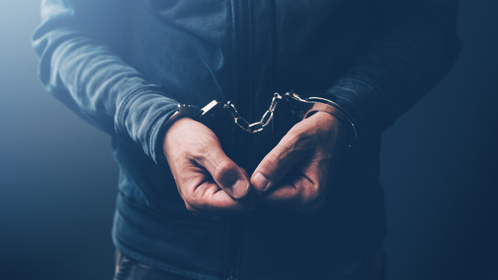 Arrested computer hacker with handcuffs pnmqubg